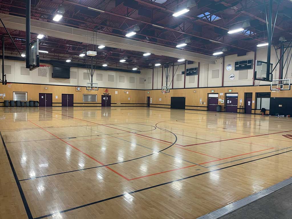 Full-size basketball court with side baskets.