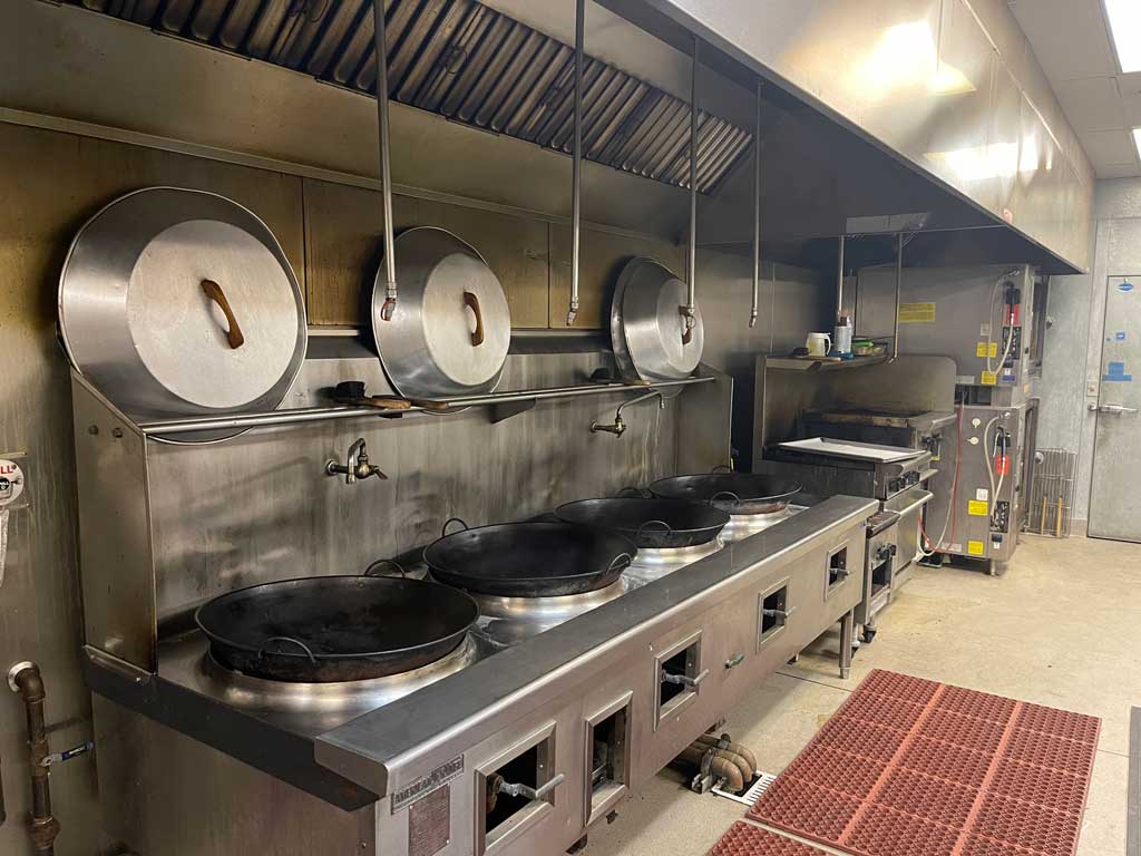 Kitchen with multiple stoves.